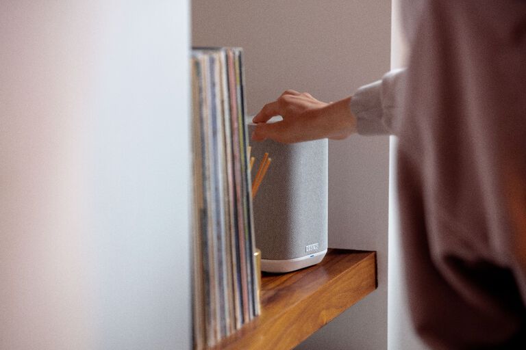 A man sitting and listening to a turntable