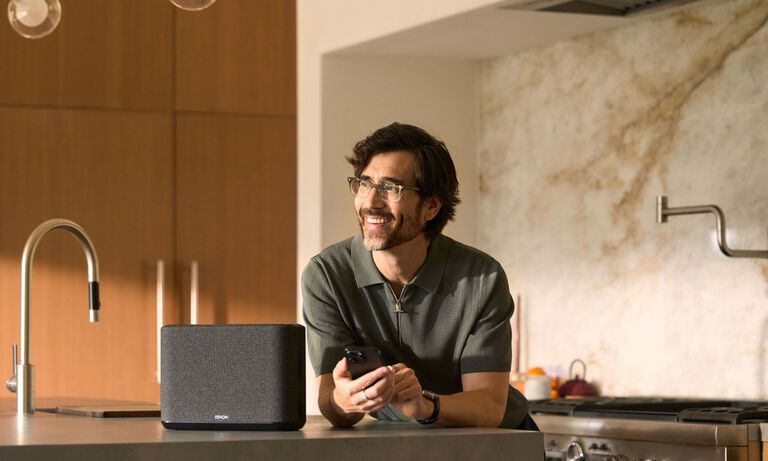 A man sitting and listening to a turntable