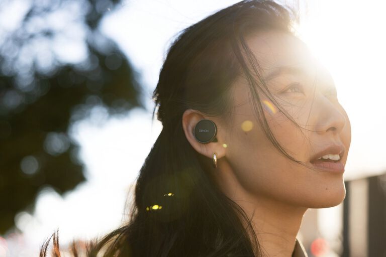 A man sitting and listening to a turntable
