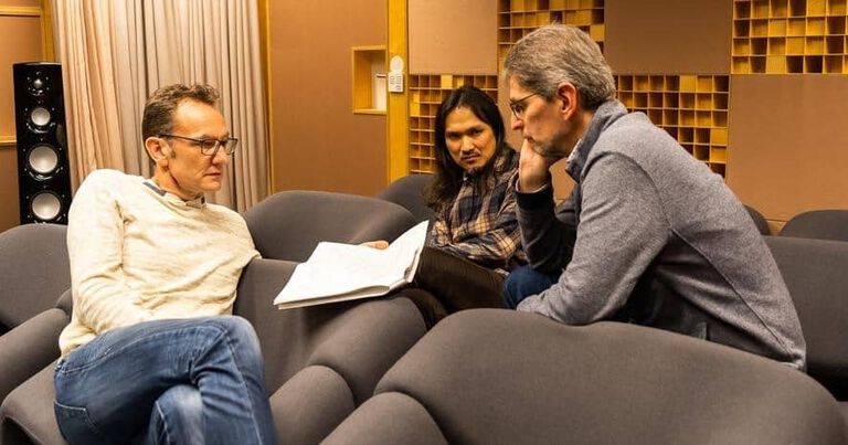 People reviewing a paper on a couch