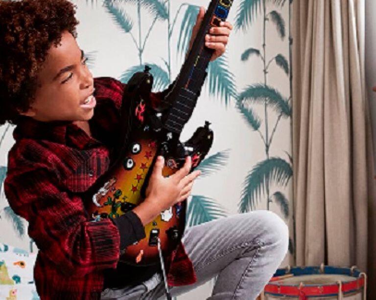 A kid playing a guitar
