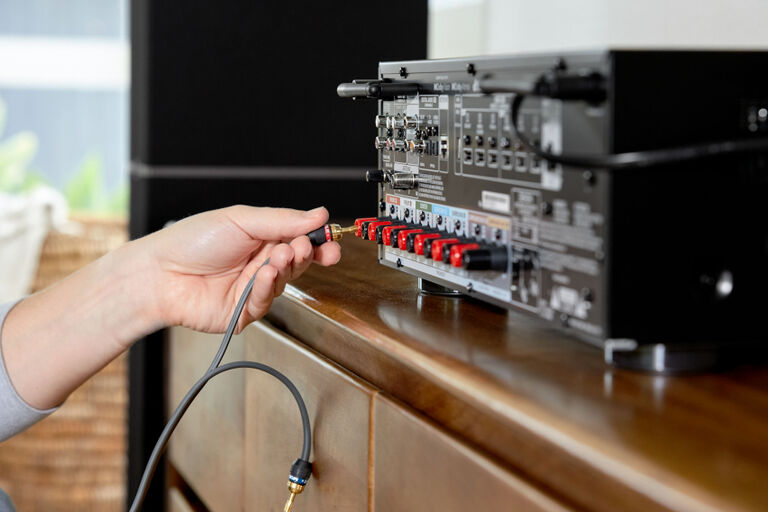 A hand plugging wires into an AVR