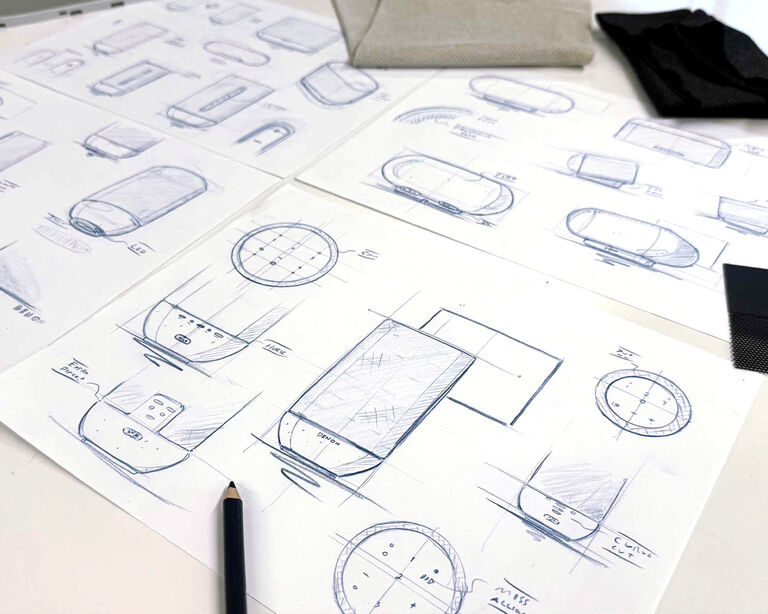 Denon 200 400 and 600 design sketches on a table