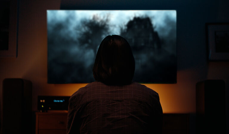 Woman watching a horror film