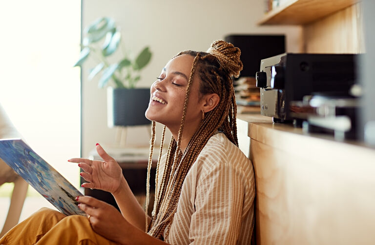 A woman singing music next to an AVR