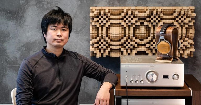 A man sitting next to Denon Headphones