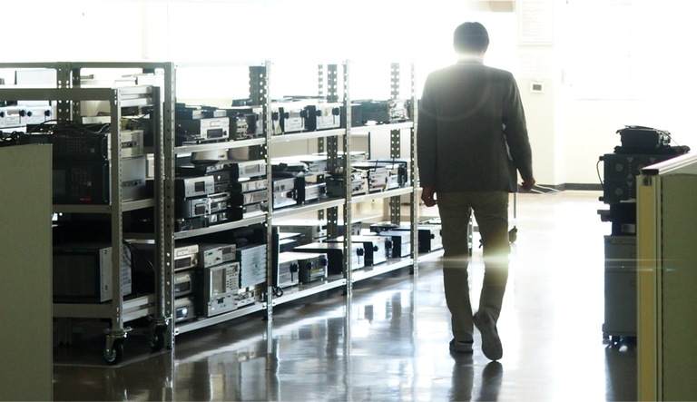 A man walking the isle of the factory