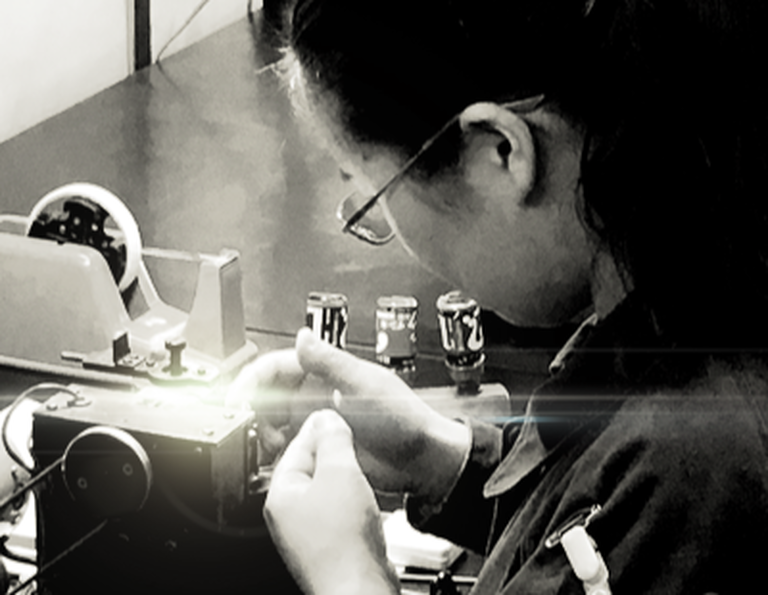 A woman building a Denon Product