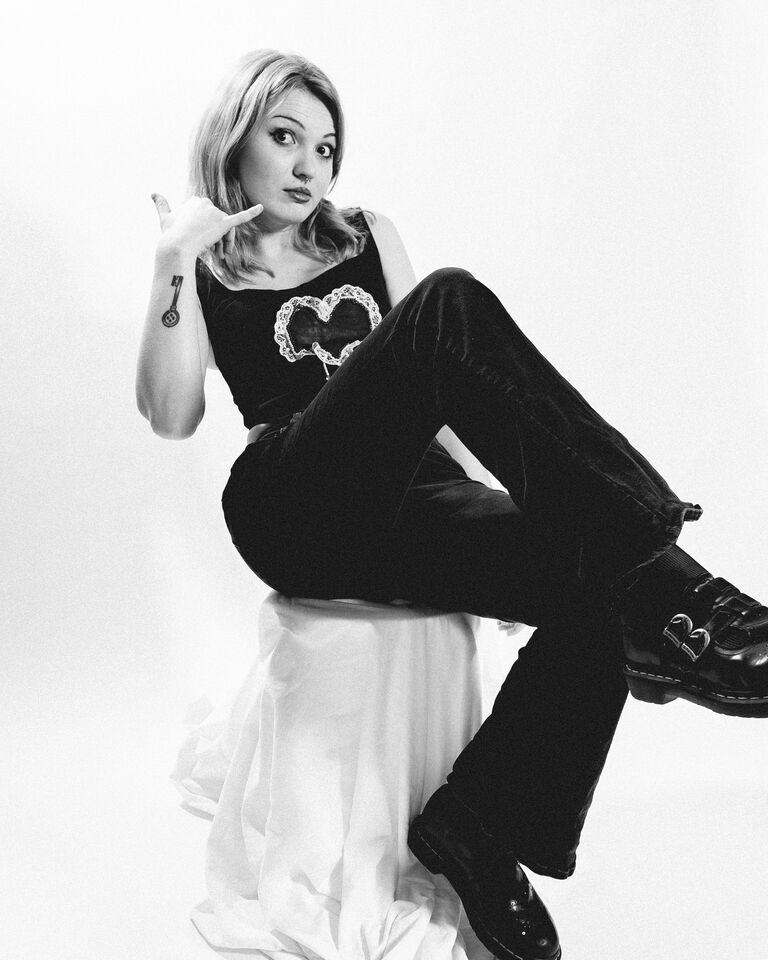 Bee Blackwell sitting on a stool