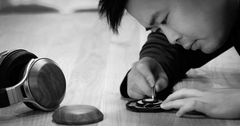 A man working on Denon Heaphones