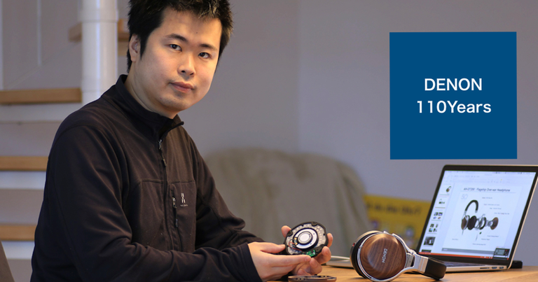 A man holding disassembled Denon Headphones