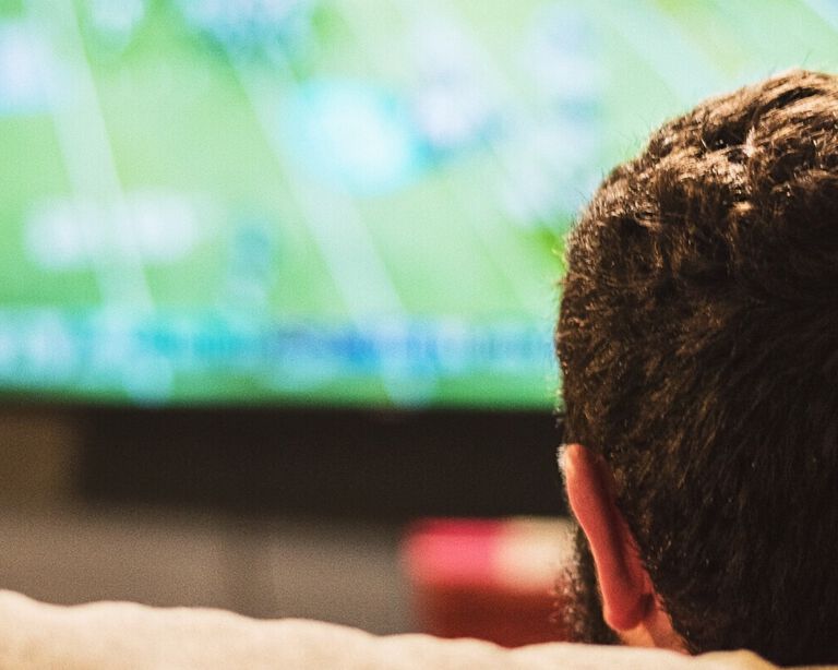 A man watching sports on TV