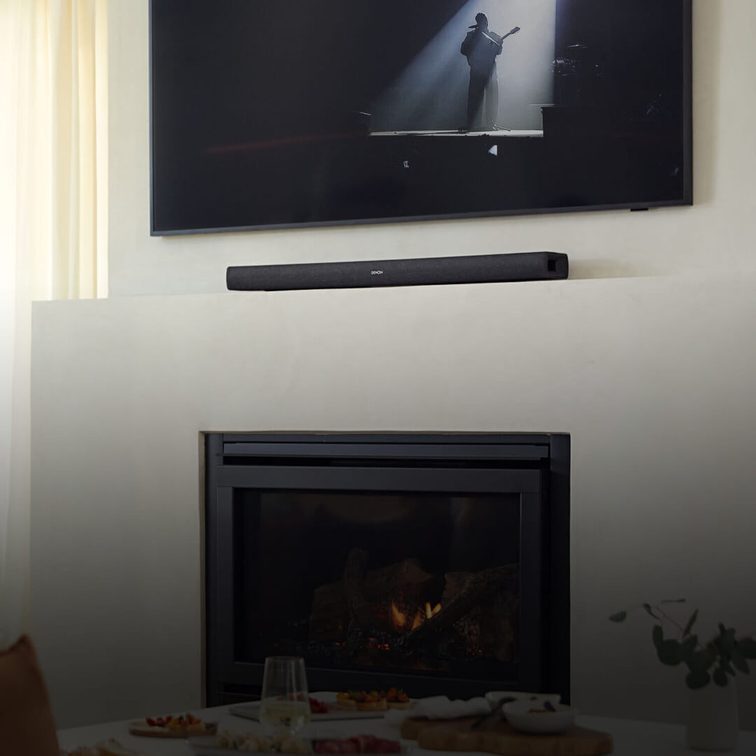 A couple listening to a Denon Sound Bar